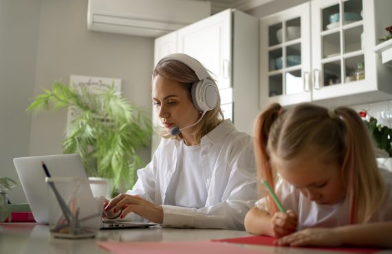 mother-working-from-home-trying-balance-family-life-with-child-job